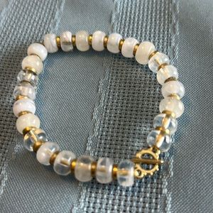 Stella & Dot stretchy bracelet with white, clear and gold beads.